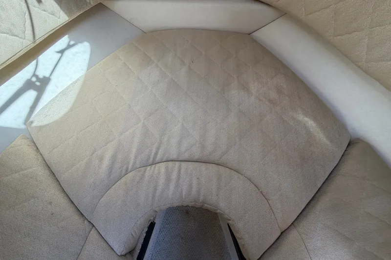 Slide: The Image of Interior cabin seating of 2007 Sea Ray 240 Sundancer boat, featuring beige upholstery. - 60