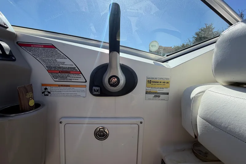 Slide: The Image of 2007 Sea Ray 240 Sundancer cockpit with steering wheel and safety warnings. - 35