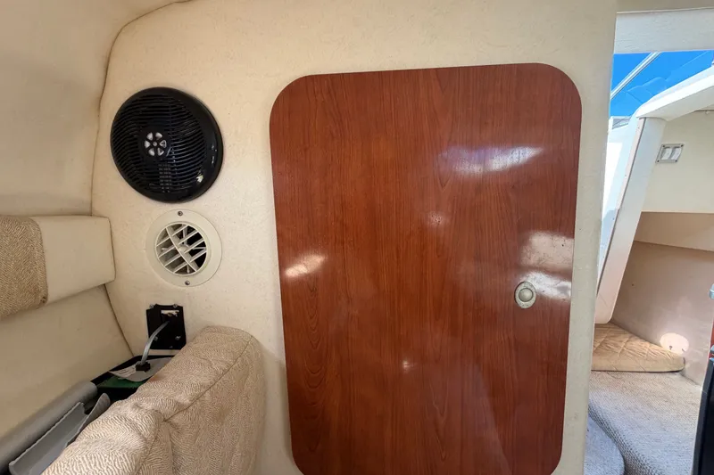 Slide: The Image of Interior cabin of 2007 Sea Ray 240 Sundancer with wood panel door and speaker. - 66