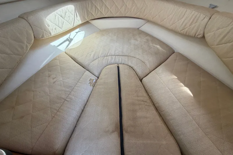 Slide: The Image of Interior seating of 2007 Sea Ray 240 Sundancer boat, featuring beige upholstery. - 56
