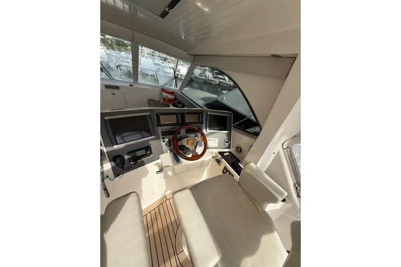 Slide: The Image of Interior cockpit of 2010 Maritimo 500 Offshore Convertible yacht, featuring navigation controls. - 17