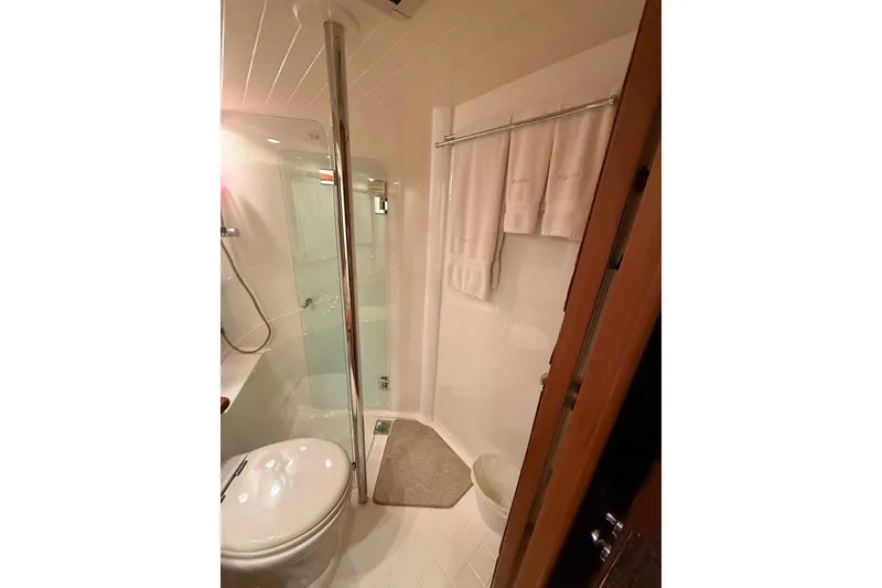 Slide: The Image of Bathroom interior of 2010 Maritimo 500 Offshore Convertible yacht, featuring shower and towels. - 31
