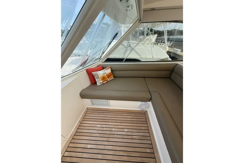 Slide: The Image of 2010 Maritimo 500 Offshore Convertible interior with cushioned seating and decorative pillows. - 15