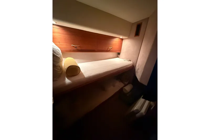 Slide: The Image of 2010 Maritimo 500 Offshore Convertible cabin with cozy bed and wooden storage. - 28