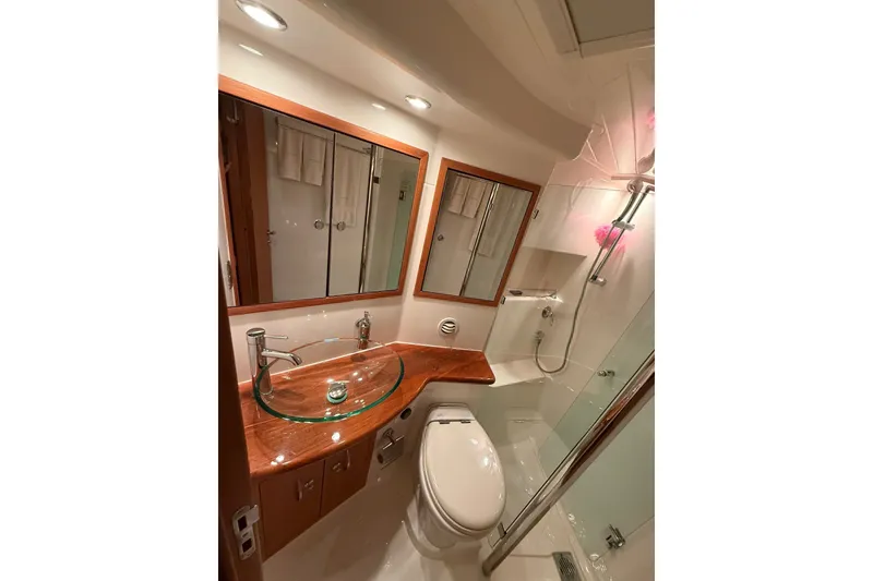 Slide: The Image of Luxurious bathroom in 2010 Maritimo 500 Offshore Convertible yacht, featuring modern fixtures and glass sink. - 27