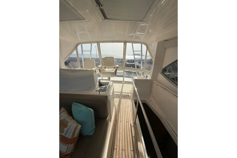 Slide: The Image of Interior view of 2010 Maritimo 500 Offshore Convertible yacht with seating and windows. - 19