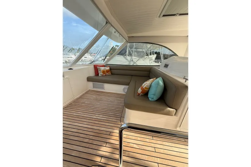 Slide: The Image of 2010 Maritimo 500 Offshore Convertible interior with cushioned seating and decorative pillows. - 21