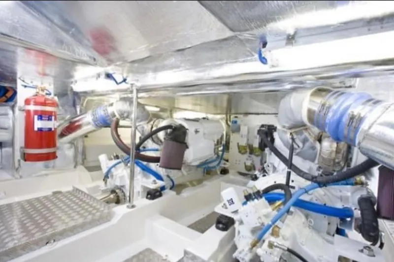 Slide: The Image of Engine room of 2010 Maritimo 500 Offshore Convertible, featuring modern equipment and fire extinguisher. - 34