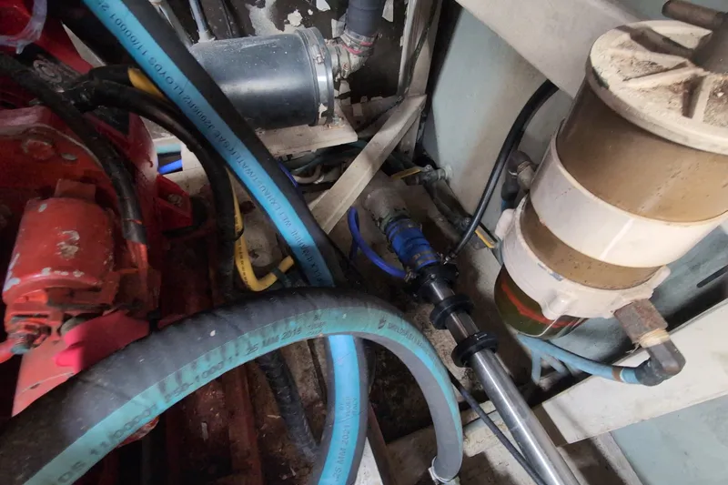 Slide: The Image of Engine compartment of a 1990 Grand Banks 36 Classic with visible hoses and filter system. - 63