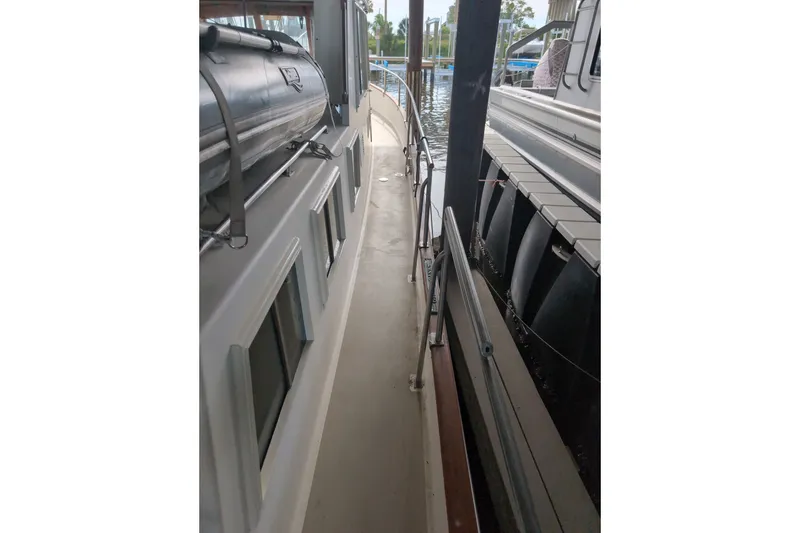 Slide: The Image of Side deck view of a 1990 Grand Banks 36 Classic yacht at a marina. - 21