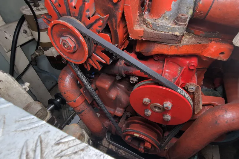 Slide: The Image of Engine compartment of a 1990 Grand Banks 36 Classic boat, featuring red mechanical components. - 65
