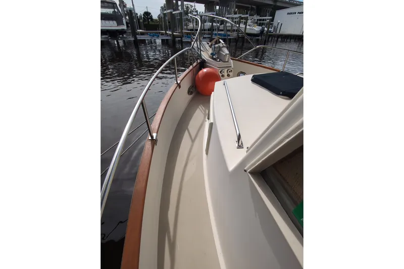 Slide: The Image of 1990 Grand Banks 36 Classic yacht deck with railing and dock view. - 12