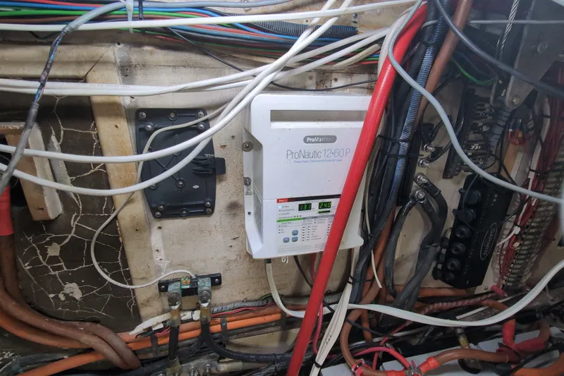Slide: The Image of Electrical wiring and ProNautic charger in a 1990 Grand Banks 36 Classic boat. - 67