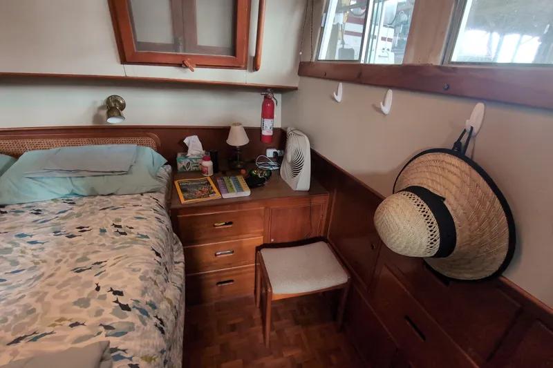 Slide: The Image of Cozy cabin interior of 1990 Grand Banks 36 Classic with bed, dresser, and nautical decor. - 47