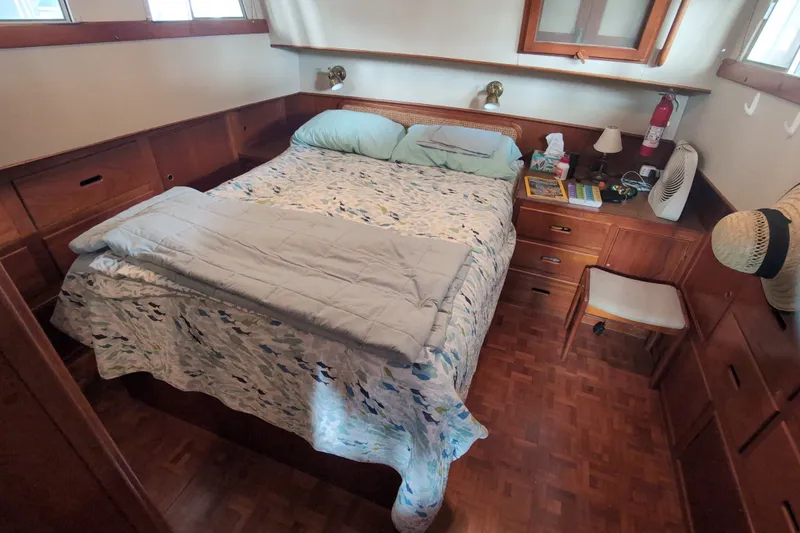 Slide: The Image of Cozy bedroom interior on a 1990 Grand Banks 36 Classic yacht with wooden furnishings. - 46