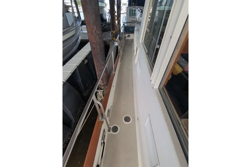 Slide: The Image of Side deck view of a 1990 Grand Banks 36 Classic yacht in a marina. - 19