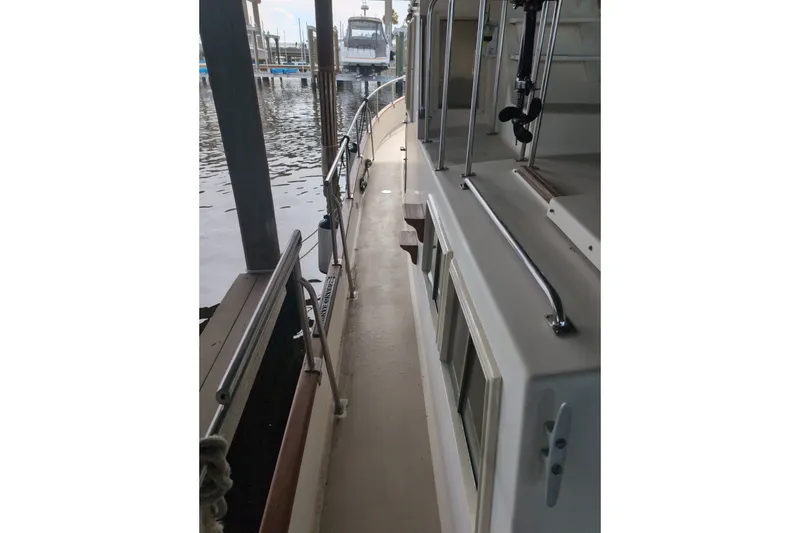 Slide: The Image of Side deck view of a 1990 Grand Banks 36 Classic yacht in a marina. - 10