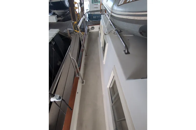 Slide: The Image of Side deck view of a 1990 Grand Banks 36 Classic yacht in a marina. - 20