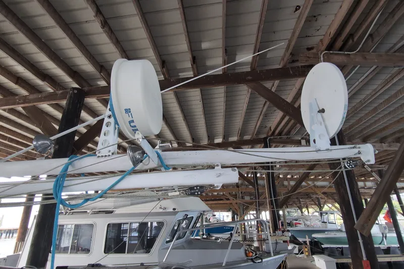 Slide: The Image of 1990 Grand Banks 36 Classic yacht under a wooden dock roof, featuring radar equipment. - 24