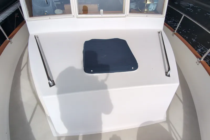Slide: The Image of 1990 Grand Banks 36 Classic yacht deck with covered hatch and railing. - 14