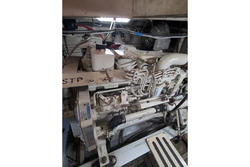 Slide: The Image of Engine room of a 1990 Grand Banks 36 Classic yacht, showcasing mechanical components. - 54