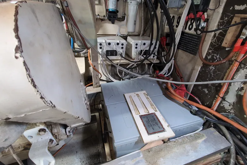 Slide: The Image of Engine room of a 1990 Grand Banks 36 Classic, showcasing wiring and machinery components. - 61