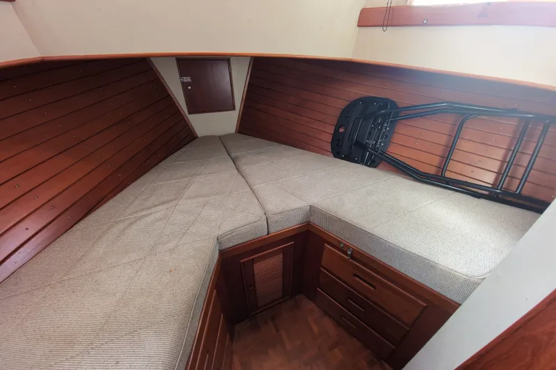Slide: The Image of Interior cabin of 1990 Grand Banks 36 Classic with wooden paneling and cushioned seating. - 42