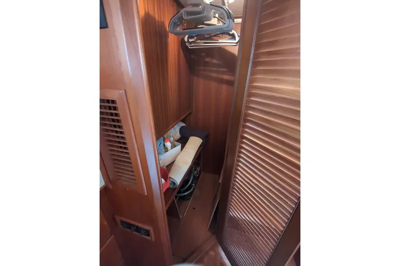 Slide: The Image of Wooden closet interior on a 1990 Grand Banks 36 Classic boat. - 51