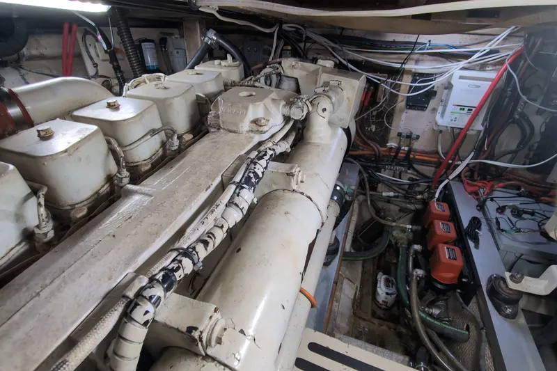 Slide: The Image of Engine room of a 1990 Grand Banks 36 Classic boat, showcasing machinery and wiring. - 56