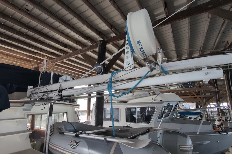 Slide: The Image of 1990 Grand Banks 36 Classic yacht in a covered marina, featuring a radar and dinghy. - 23