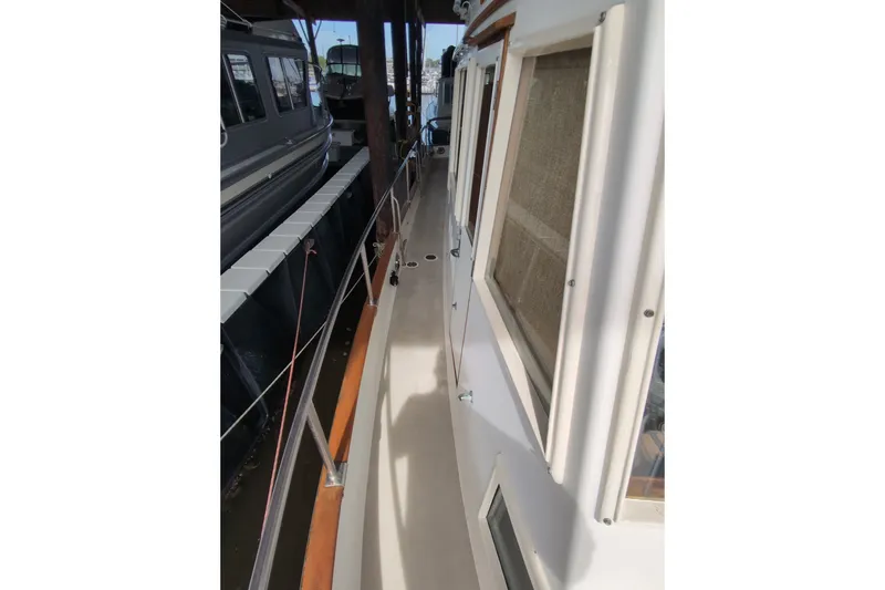 Slide: The Image of Side deck view of a 1990 Grand Banks 36 Classic yacht, showcasing its sleek design. - 18
