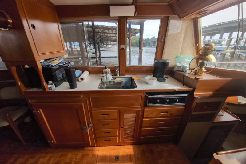 Slide: The Image of Interior of a 1990 Grand Banks 36 Classic yacht kitchen with wooden cabinetry and appliances. - 34