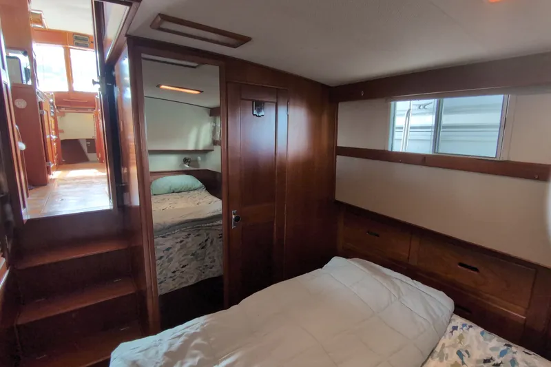 Slide: The Image of Interior of 1990 Grand Banks 36 Classic yacht, featuring cozy wooden cabin with beds. - 50