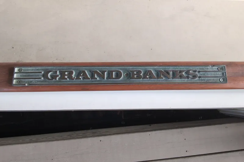 Slide: The Image of Plaque displaying "Grand Banks" on a 1990 Grand Banks 36 Classic boat. - 8