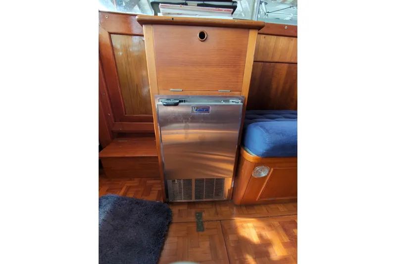 Slide: The Image of Interior of 1990 Grand Banks 36 Classic with wooden cabinetry and stainless steel fridge. - 33