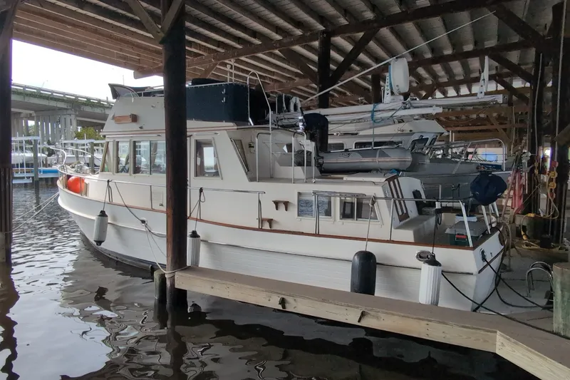 Slide: The Image of 1990 Grand Banks 36 Classic yacht docked under a covered marina. - 3