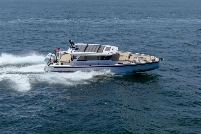 The Image of 2027 Axopar 38 Cross Cabin cruising on open water, showcasing sleek design and performance. - 1