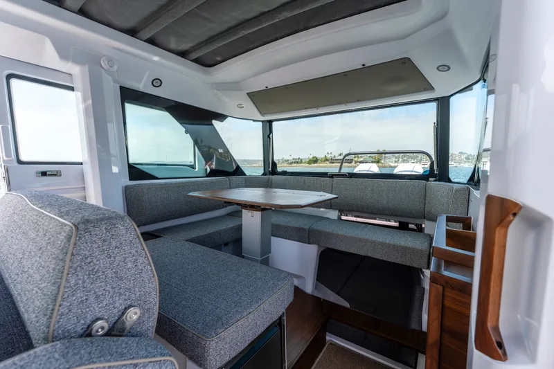 Slide: The Image of Interior of 2027 Axopar 38 Cross Cabin with modern seating and table. - 26