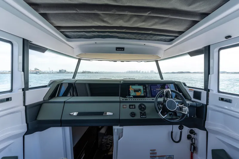 Slide: The Image of Interior view of 2027 Axopar 38 Cross Cabin boat with modern dashboard and steering. - 27