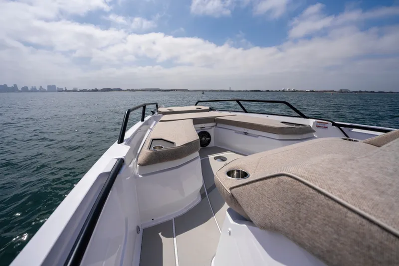 Slide: The Image of 2027 Axopar 38 Cross Cabin boat on open water, featuring spacious seating and sleek design. - 14