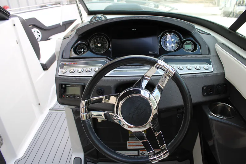 Slide: The Image of Dashboard of a 2021 Monterey 255SS Super Sport boat with sleek steering wheel. - 28