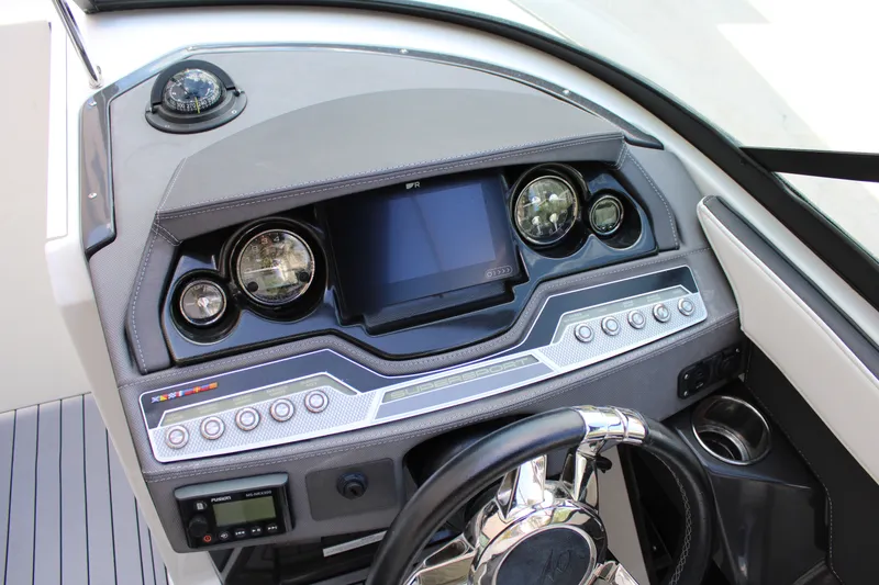 Slide: The Image of Dashboard of a 2021 Monterey 255SS Super Sport boat with modern controls and steering wheel. - 27