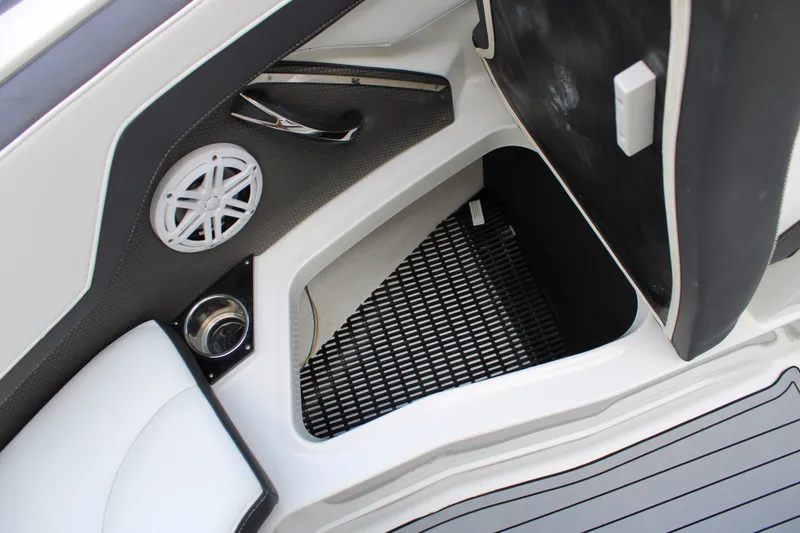 Slide: The Image of Interior storage compartment of 2021 Monterey 255SS Super Sport boat with speaker and cup holder. - 20