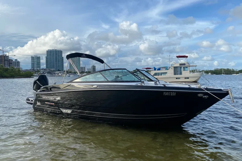 The Image of 2021 Monterey 255SS Super Sport boat on water with city skyline background. - 0