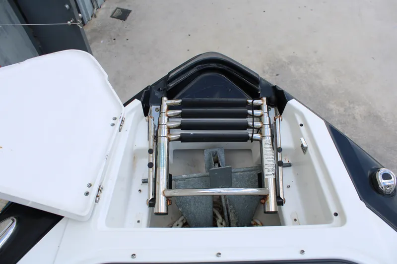 Slide: The Image of 2021 Monterey 255SS Super Sport boat anchor compartment with ladder and storage. - 17
