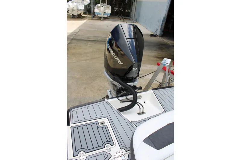 Slide: The Image of 2021 Monterey 255SS Super Sport boat with Mercury outboard engine, docked on a concrete surface. - 45