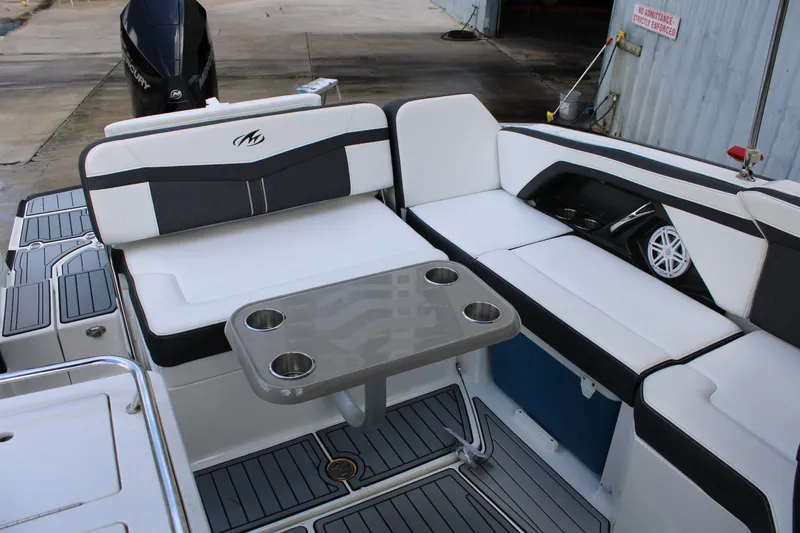 Slide: The Image of 2021 Monterey 255SS Super Sport boat interior with seating and cupholder table. - 36