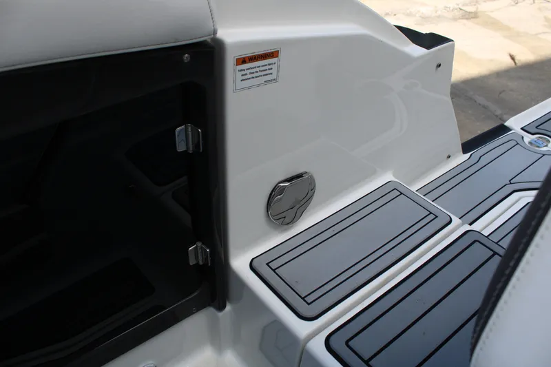 Slide: The Image of 2021 Monterey 255SS Super Sport boat interior with storage compartment and sleek flooring design. - 42