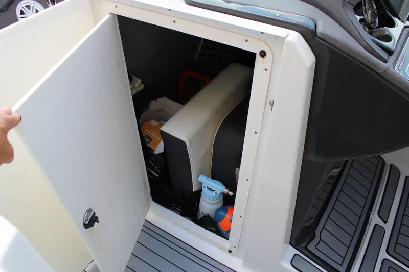 Slide: The Image of Storage compartment of 2021 Monterey 255SS Super Sport boat, showing various items inside. - 31