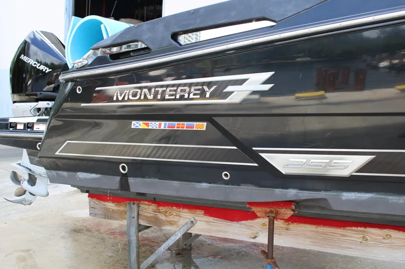 Slide: The Image of 2021 Monterey 255SS Super Sport boat on stand, showcasing sleek design and branding. - 5